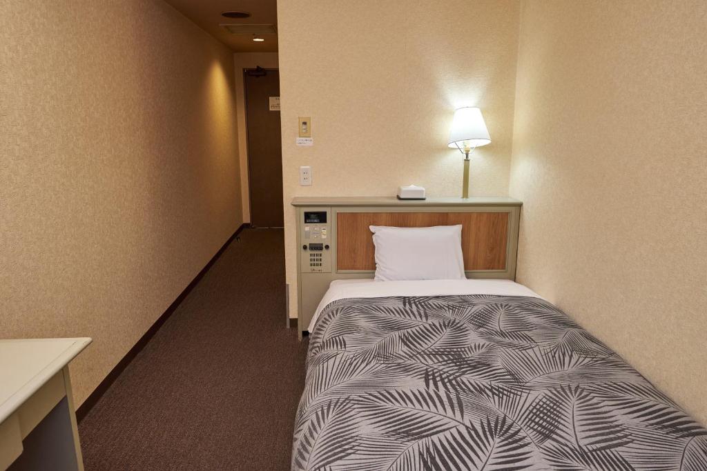 Postel nebo postele na pokoji v ubytování Hotel Machida Villa