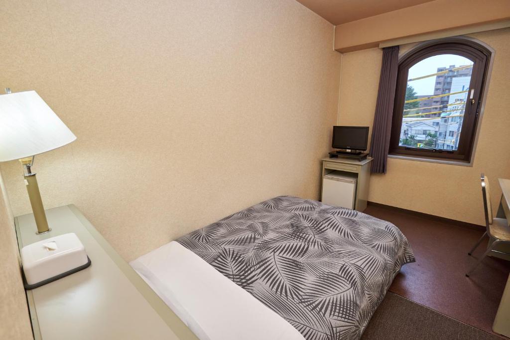 Postel nebo postele na pokoji v ubytování Hotel Machida Villa