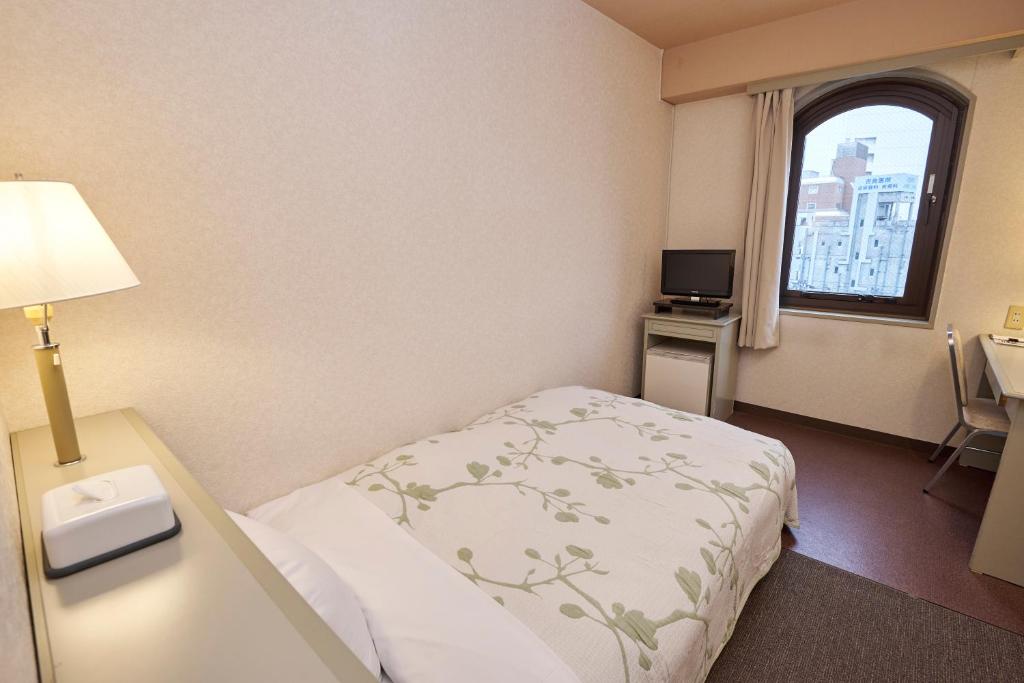 Postel nebo postele na pokoji v ubytování Hotel Machida Villa