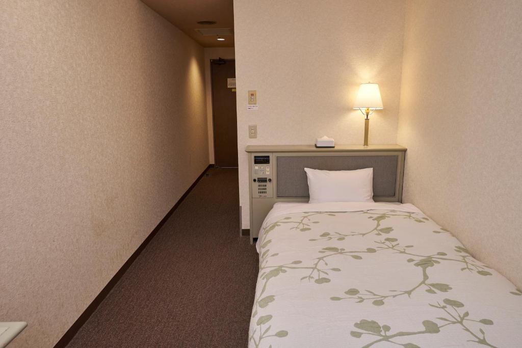 Postel nebo postele na pokoji v ubytování Hotel Machida Villa