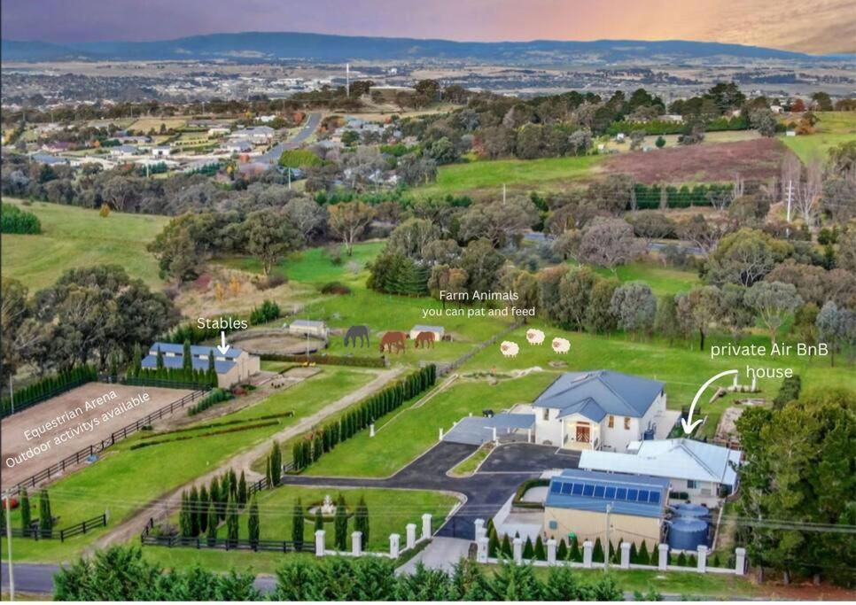 an aerial view of a farm with buildings and trees at Delaware Retreat in Mount Panorama