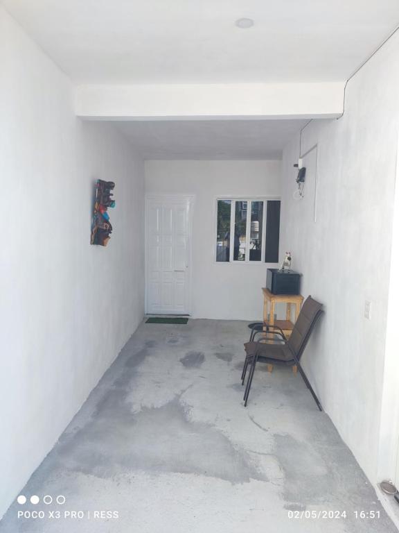 an empty room with a chair and a table at Tierra Maya in Playa del Carmen