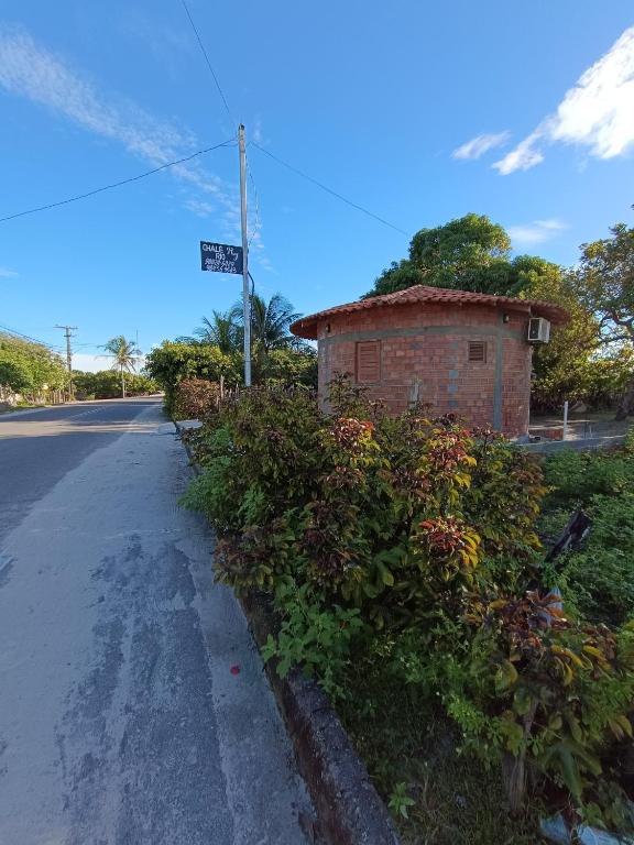 a brick building on the side of a road at Chalé Rj Rio in Santo Amaro