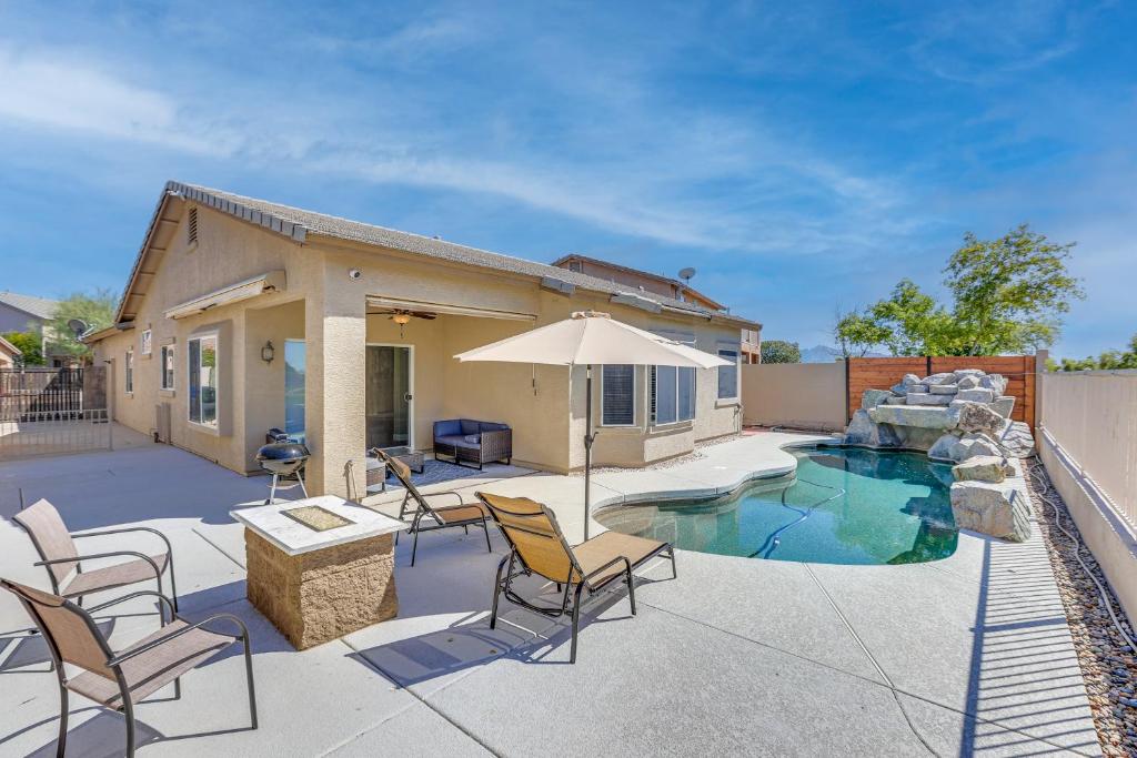 a patio with chairs and an umbrella and a pool at Coldwater Golf Course Getaway in Avondale! in Avondale