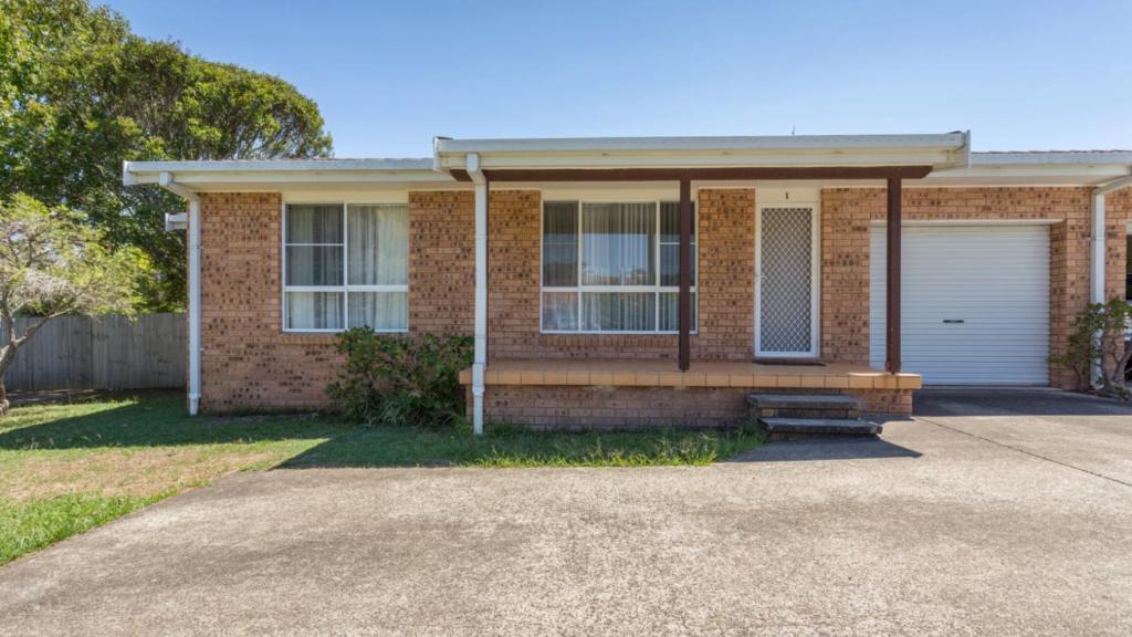 a brick house with a garage and a driveway at Beachcomber in Old Bar
