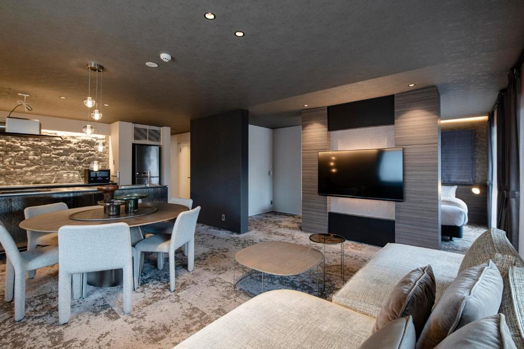 a living room with a couch and a table at HOTEL MASTAY jingumichi in Kyoto