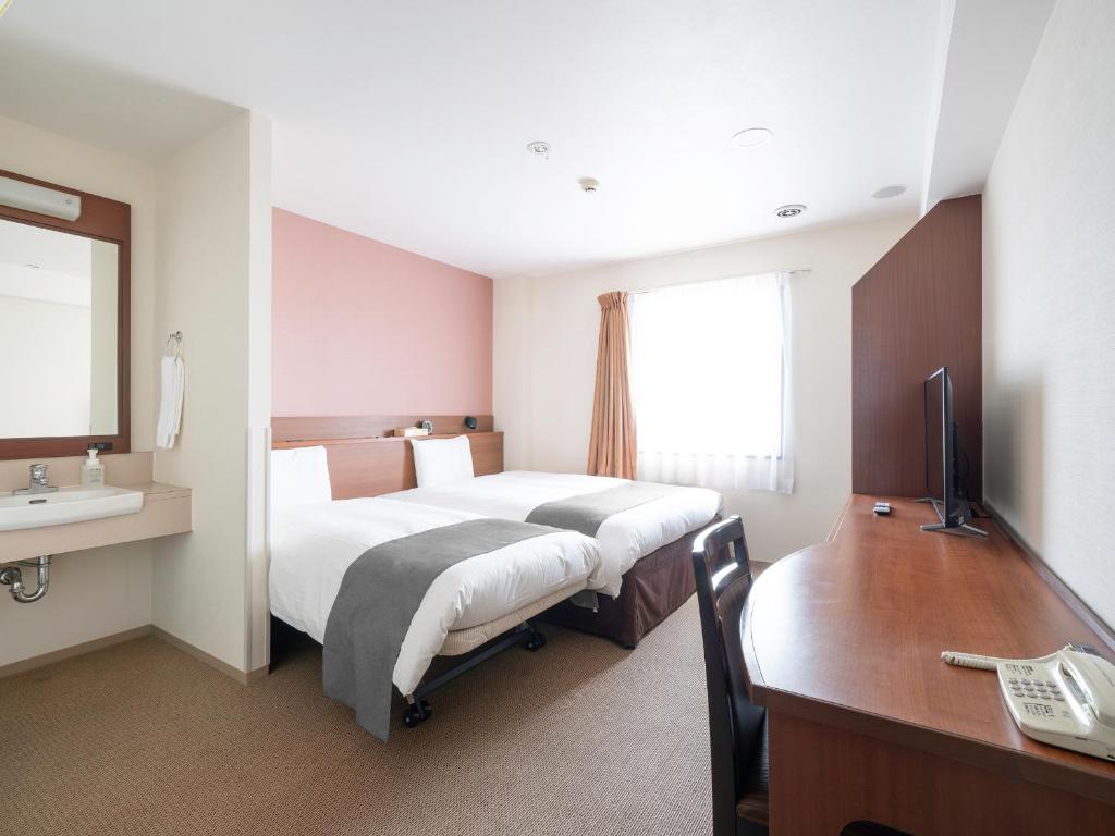 Postel nebo postele na pokoji v ubytování Vessel Hotel Kanda Kitakyushu Airport