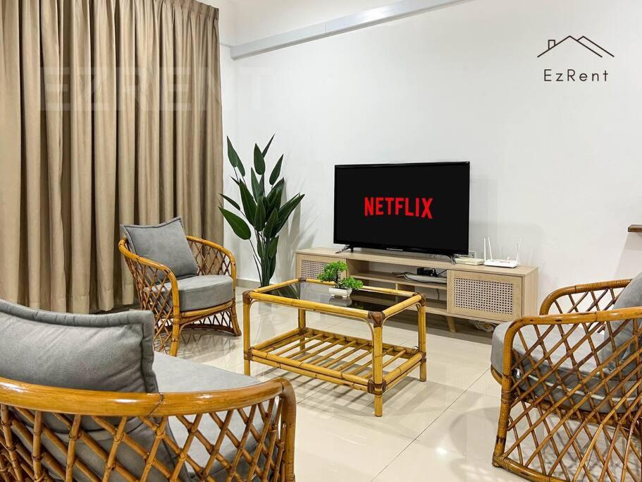 a living room with a tv and some chairs at Taiping Lake Garden Peaceful Retreat near Zoo Taiping in Taiping