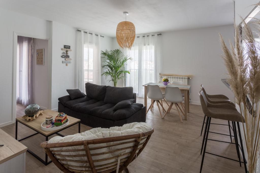 a living room with a couch and a table at Appartement T2 proche centre ville in Istres
