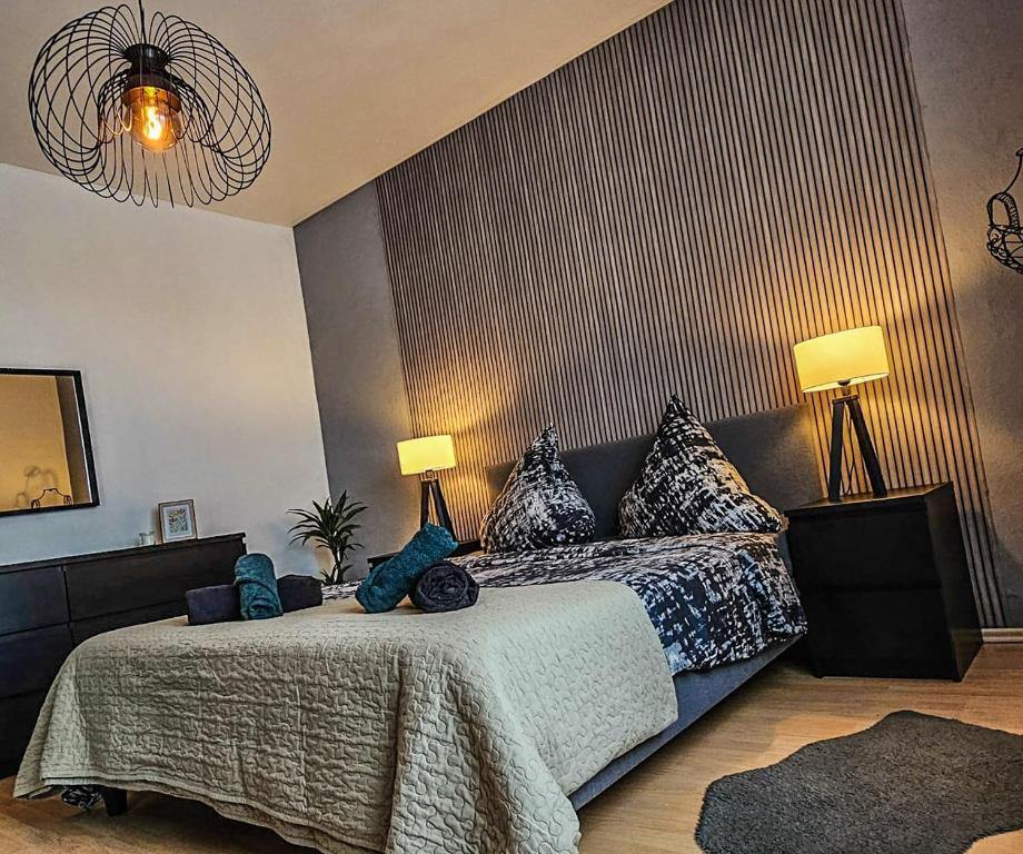 a bedroom with a bed with blue pillows on it at Apartment Sophia in Hamm
