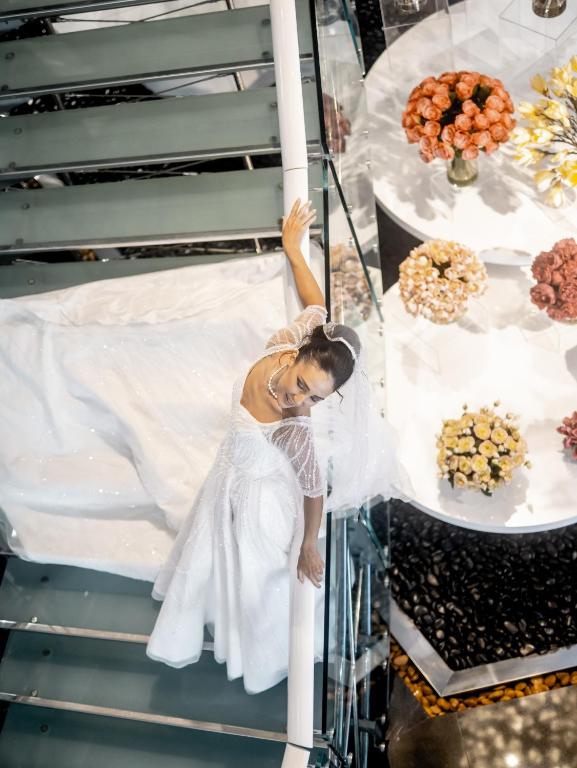 a woman in a wedding dress standing on a bed at Golden Sands Boutique Hotel-Dubai Creek in Dubai