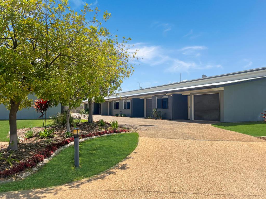 a building with a driveway in front of it at Direct Collective - Villas on Rivergum in Emerald