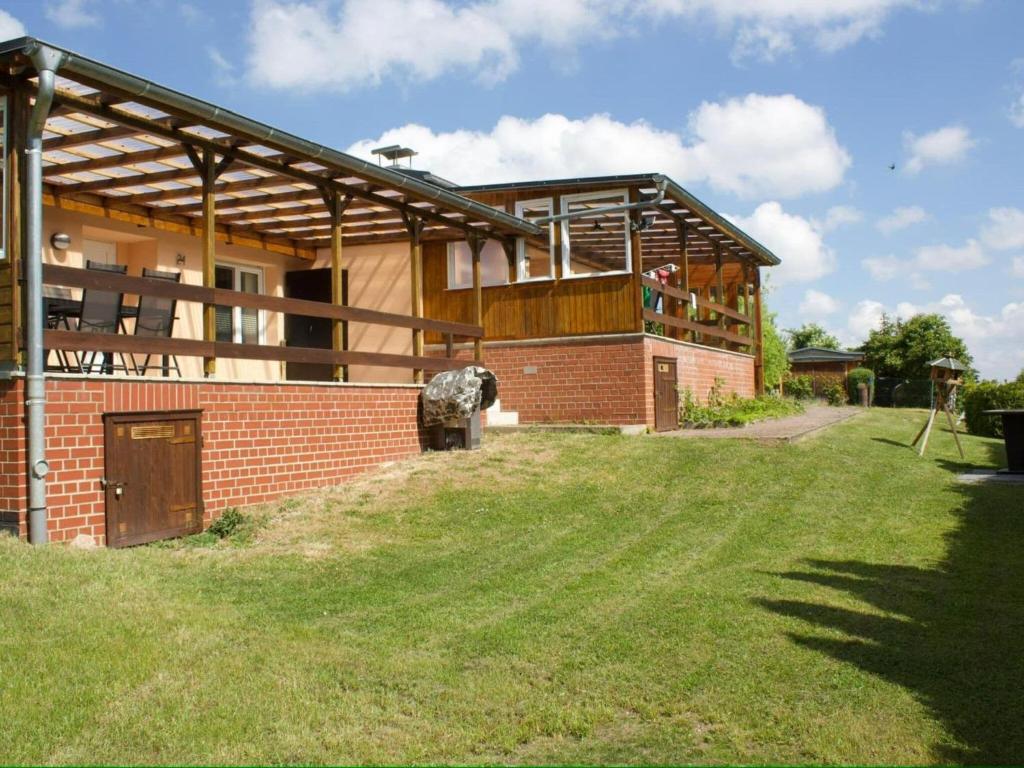 a brick building with a porch and a grass yard at Comfort Near Castle Views in Blankenburg