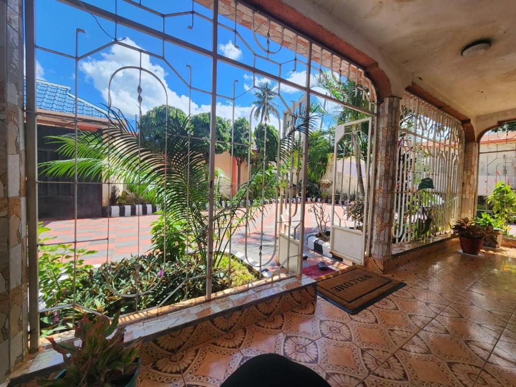 een kamer met een groot raam met planten bij G & S Executive Lodge in Dar es Salaam