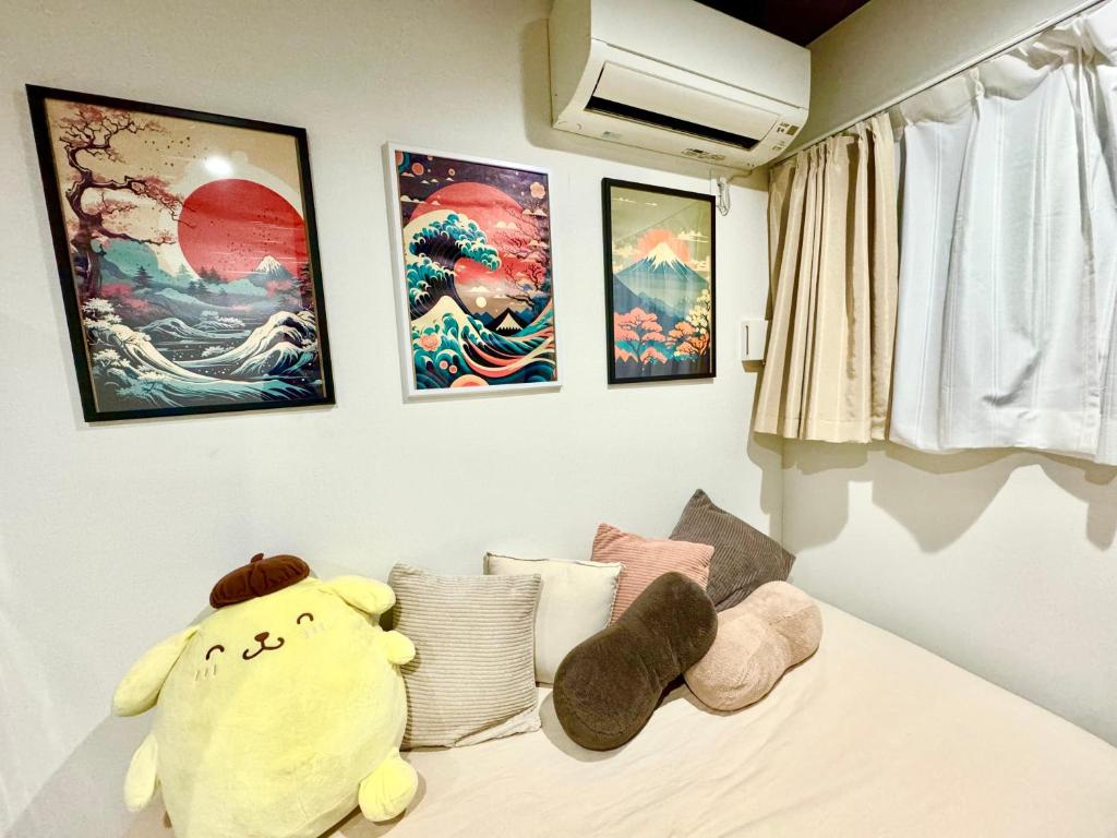 a bedroom with a stuffed animal sitting on a bed at 西九条 CHILL - Nishikujo CHILL in Osaka