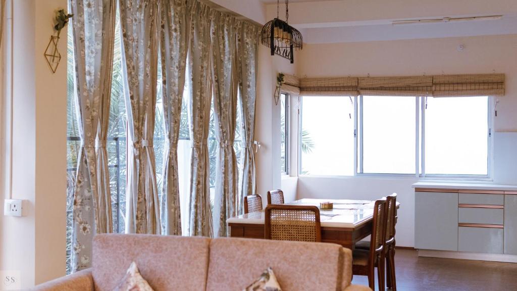 a living room with a table and a couch at Genesis villa in Guwahati