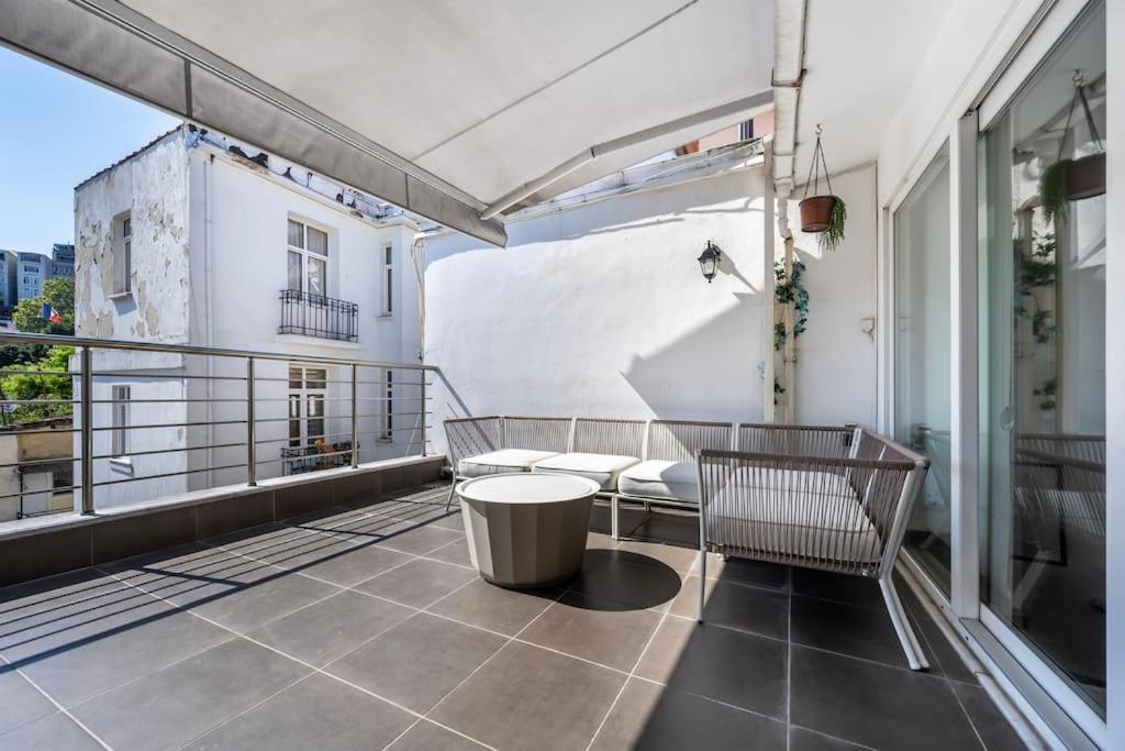 a balcony with a table and chairs on a building at Stylish Duplex House with a Special Terrace in Istanbul