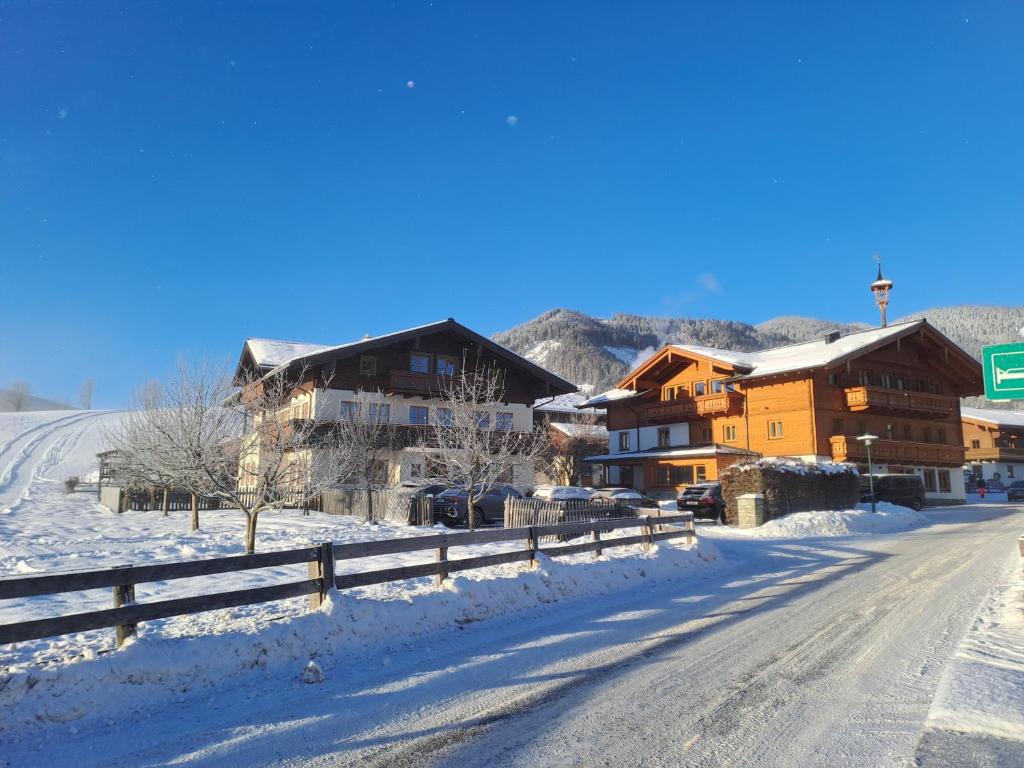 a snow covered street in a town with buildings at Appartment Ransburggut in Flachau