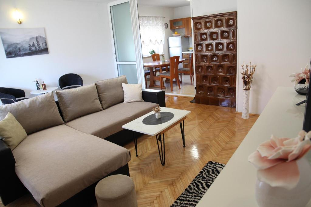 ein Wohnzimmer mit einem Sofa und einem Tisch in der Unterkunft Apartments Kresan in Zadar