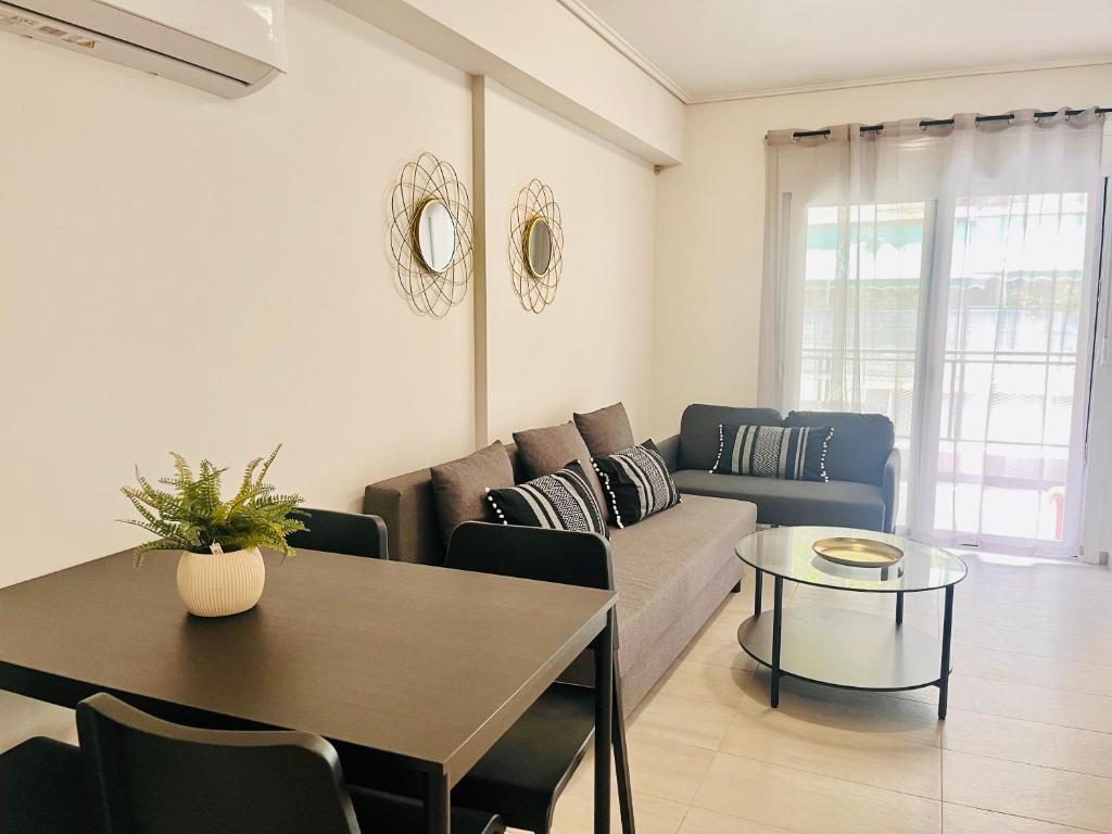a living room with a couch and a table at Elvita Apartments 4 in Athens