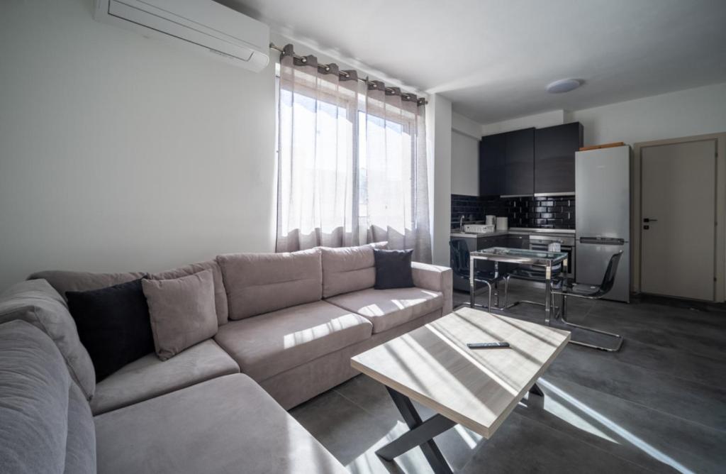 a living room with a couch and a table at Exclusive ladadika apartment 1 in Thessaloniki