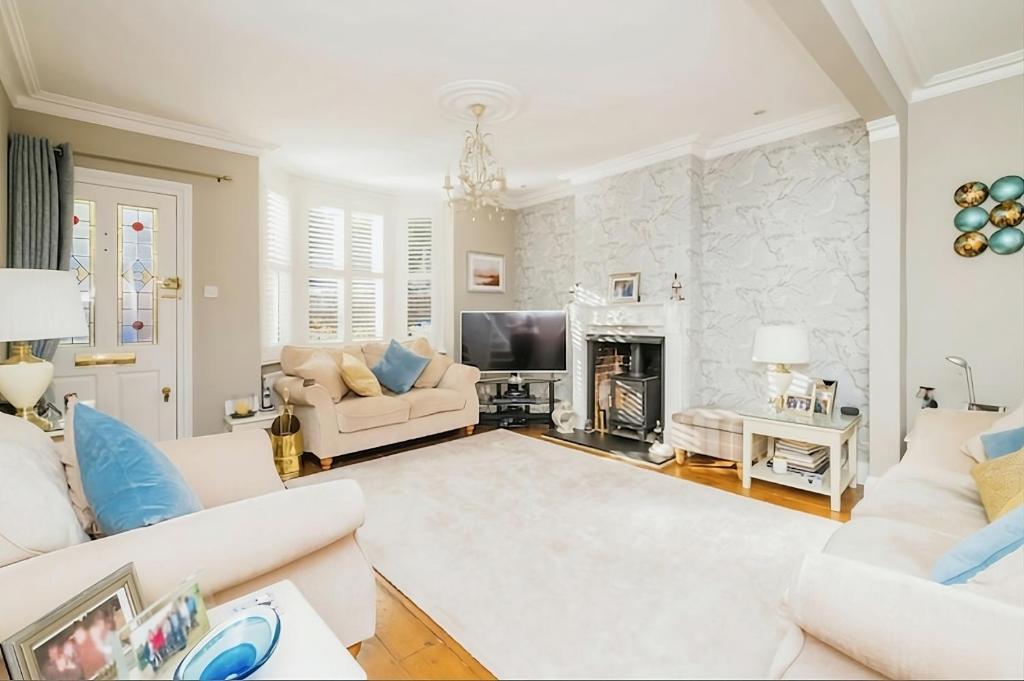 a living room with white furniture and a fireplace at 3 Bedroom Cottage in Sunninghill, Ascot in Sunninghill