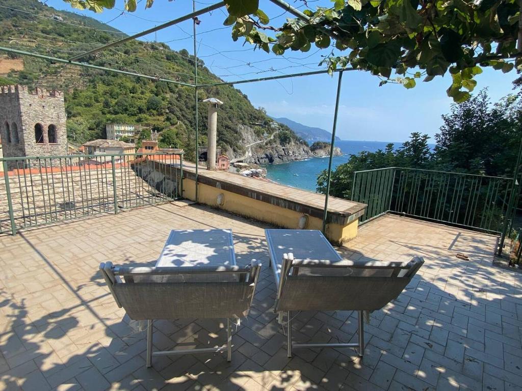 a table and chairs on a patio with a view at La Terrazza sul Mare Sea View - near best beaches in Monterosso al Mare