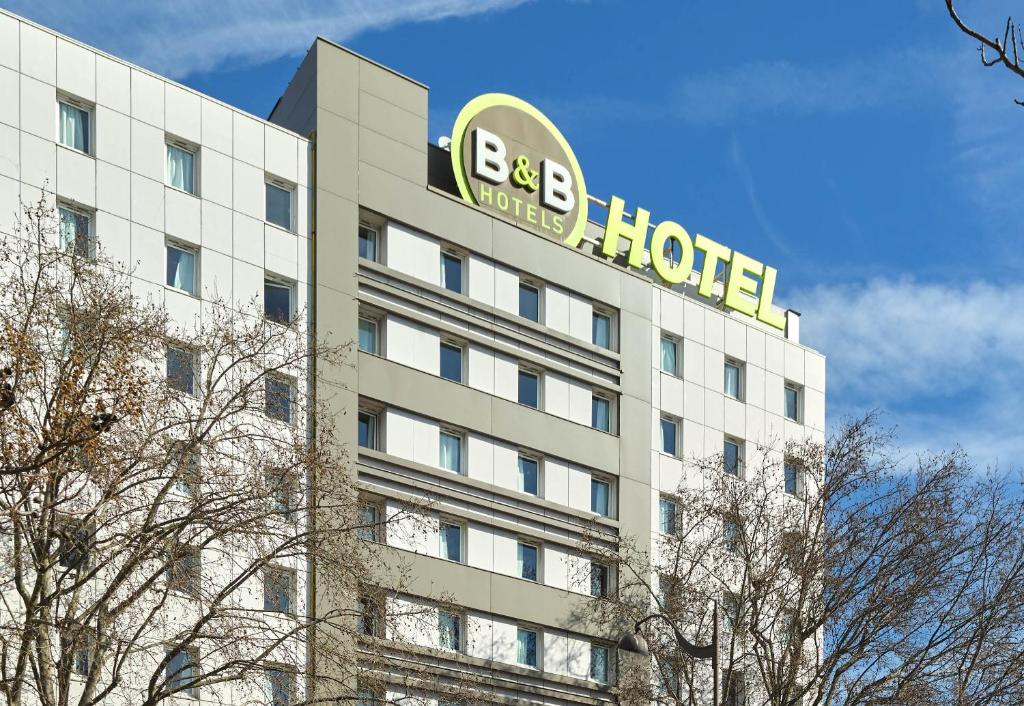 a building with a hotel sign on top of it at B&B HOTEL Paris Porte de la Villette in Paris