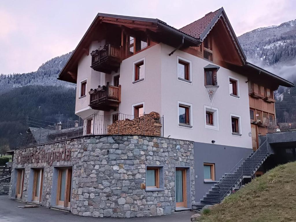 a large building on top of a stone wall at Chalet La Rugiada in Valdisotto
