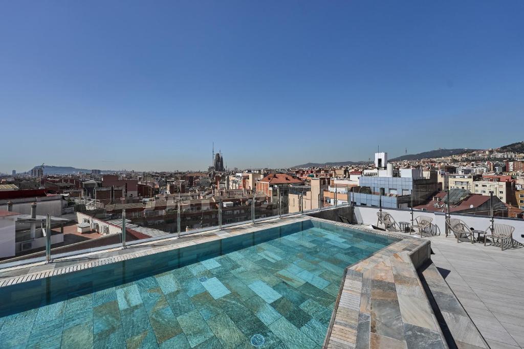 a swimming pool on the roof of a building at Catalonia Atenas in Barcelona
