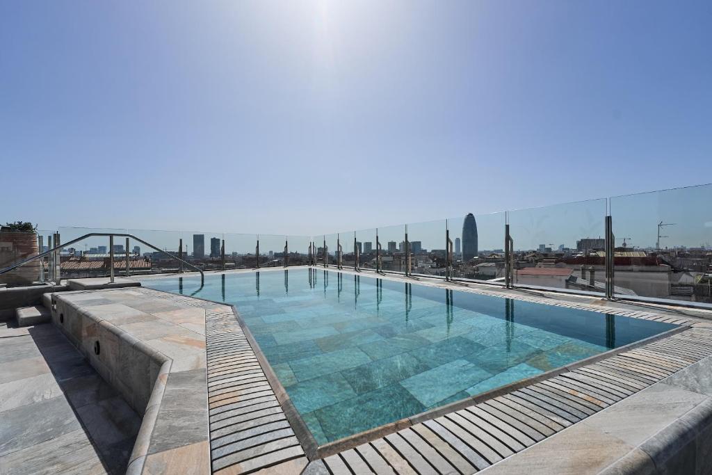 a large swimming pool on top of a building at Catalonia Atenas in Barcelona