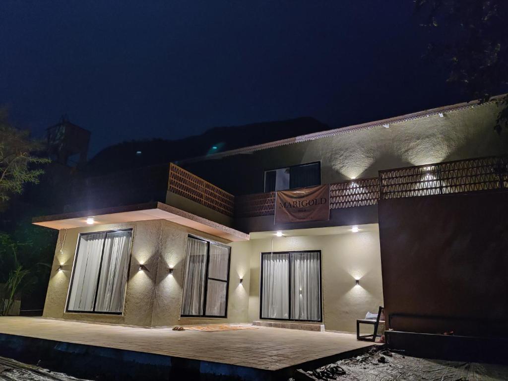 a house is lit up at night at The Marigold Villa in Pune