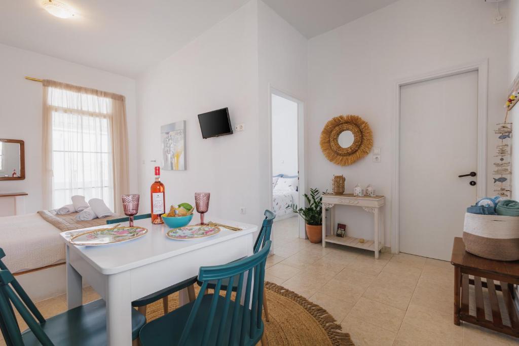 a kitchen and living room with a table and chairs at Studios Eliza in Livadi