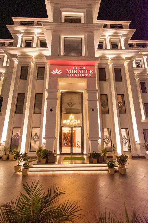 a large building with a sign in front of it at Hotel Miracle Resort in Phagwāra