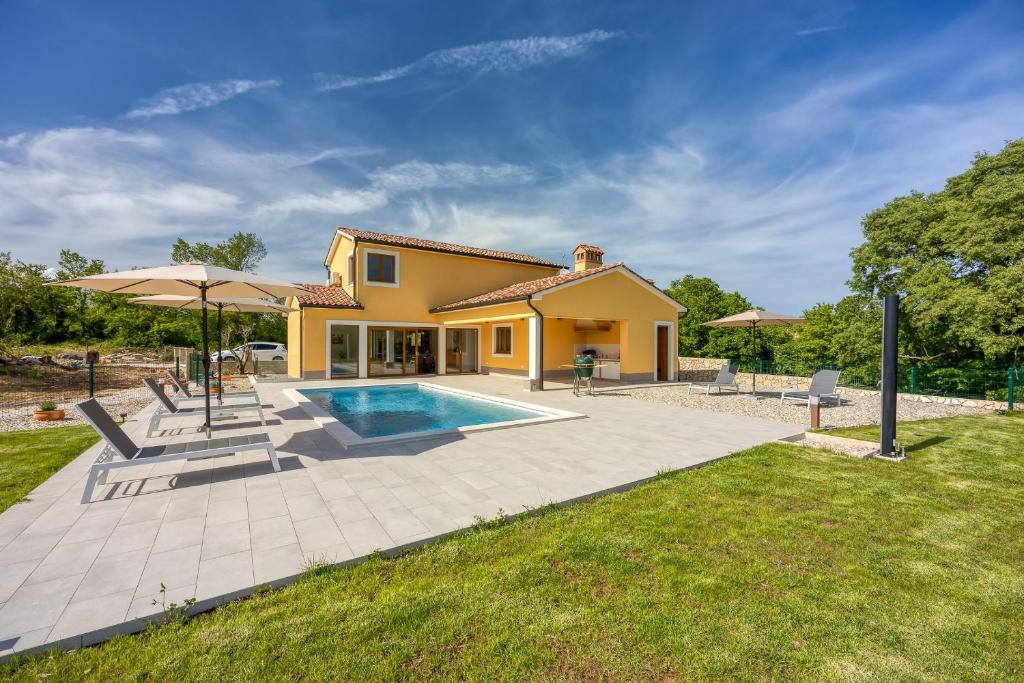 a villa with a swimming pool and a house at Villa AnaLucija in Labin