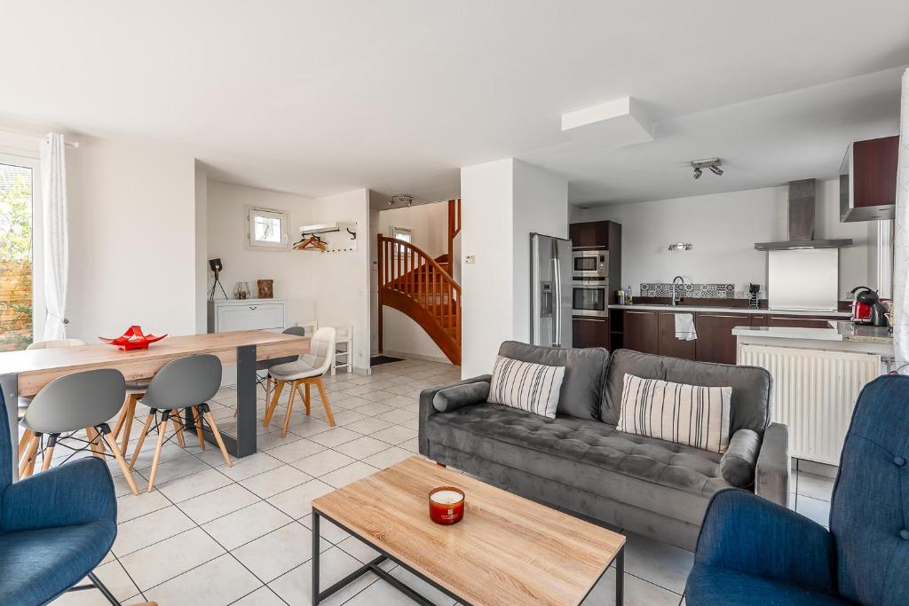 a living room with a couch and a table at Lake House 4 Bedroomed near Disneyland Paris in Serris