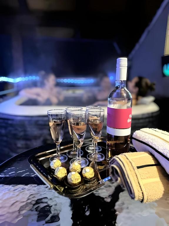 a tray of champagne glasses and a bottle of wine at Apartment Ana with a Charming Jacuzzi near Marija Bistrica in Veliki Komor