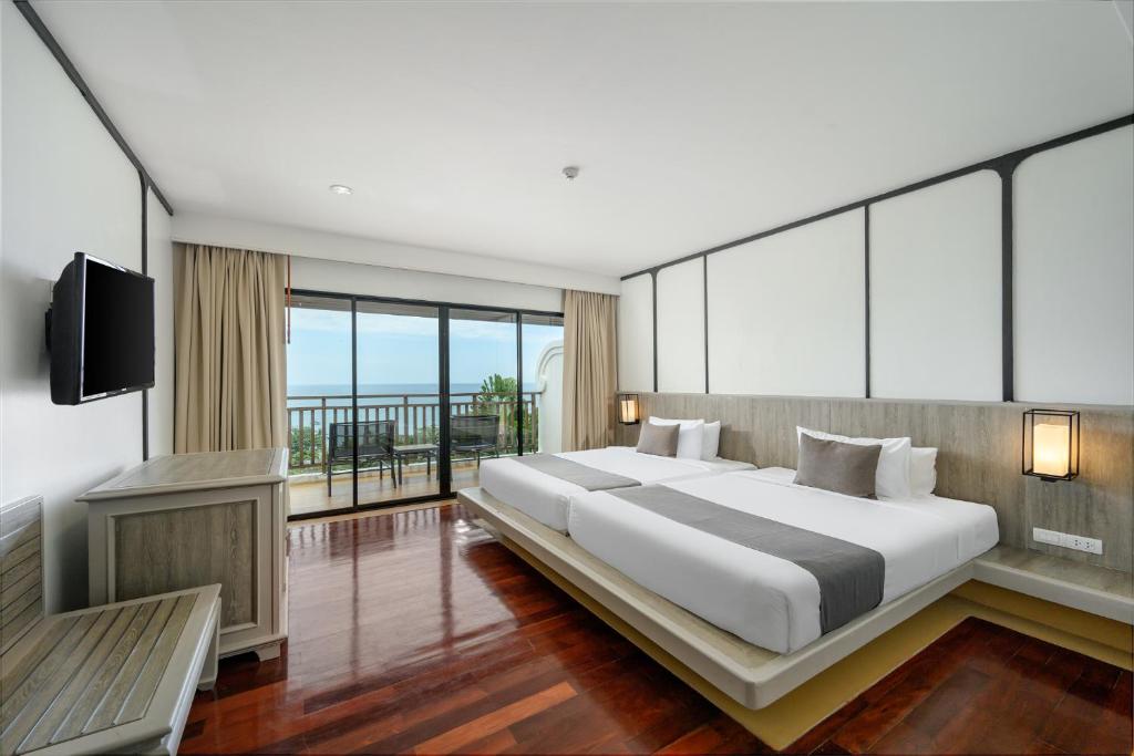 Postel nebo postele na pokoji v ubytování Andamantra Resort and Villa Phuket - SHA Extra Plus