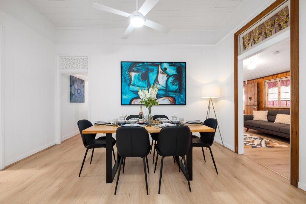 a dining room with a table and chairs at Heritage 5BR Queenslander- Walk to CBD&South Bank, 3 Parking in Brisbane