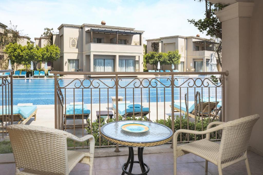 a balcony with a table and chairs and a pool at Spice Hotel & Spa - Ultra All Inclusive in Belek