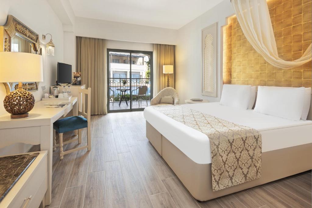 a hotel room with a bed and a desk at Spice Hotel & Spa - Ultra All Inclusive in Belek