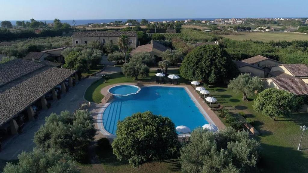 an aerial view of a house with a swimming pool at Borghetto Beach Club Resort in Capo Rizzuto