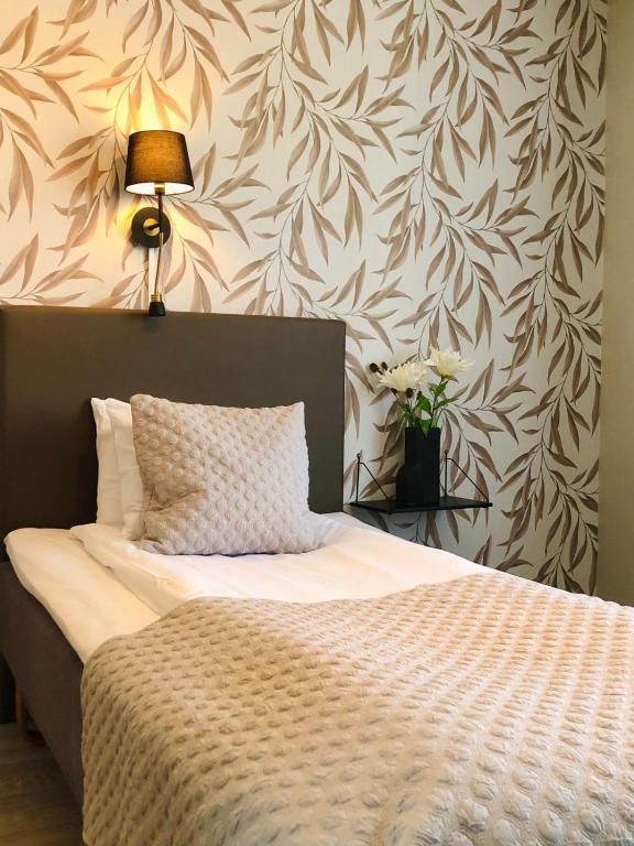 Postel nebo postele na pokoji v ubytování Arena Hotell