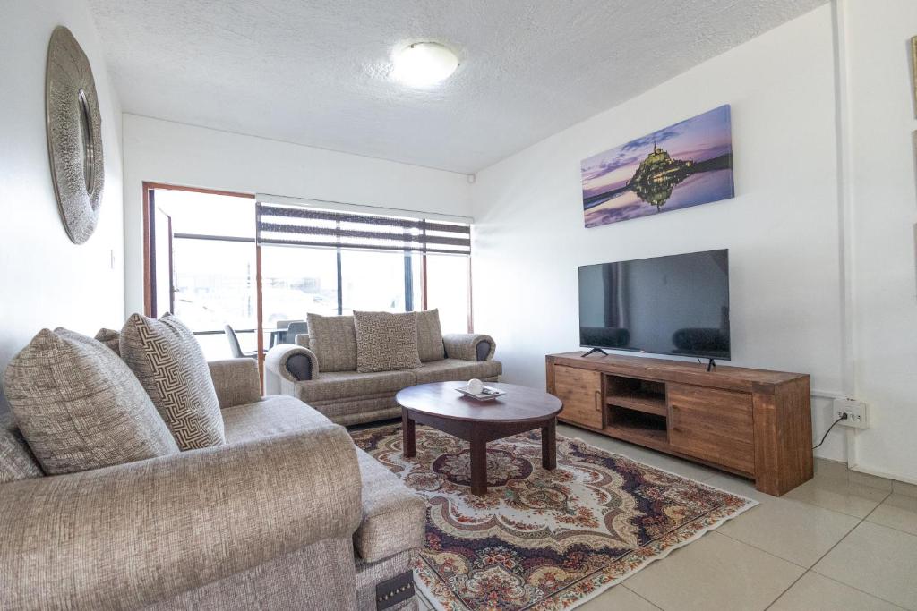 a living room with a couch and a tv at Safi Classic 3 bedroom Apartment 4 in East London