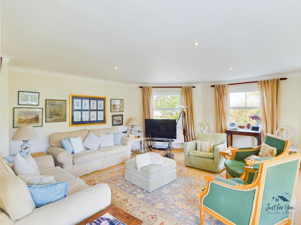 a living room with couches and chairs at 16 Solent Landing in Bembridge