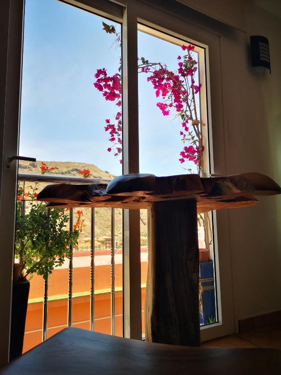 a table in front of a window with a view at Puerto de Mogan Sonneland in Puerto de Mogán