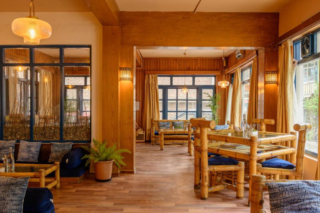 a dining room with a table and chairs at Drifters Inn - The Hidden Tribe in Manāli