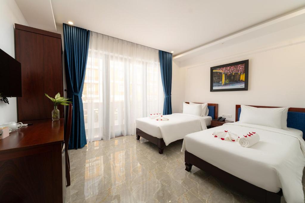 Giường trong phòng chung tại May Boutique Villa Hội An