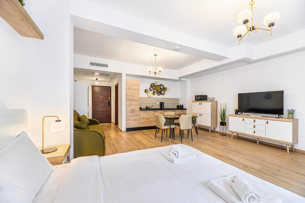 a bedroom with a bed and a living room at Clabucet Alpin Studio in Predeal