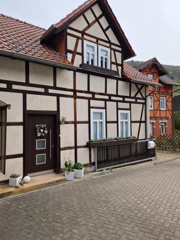 a black and white building with a balcony at Ferienhaus Reschwitzer Auszeit in Saalfeld